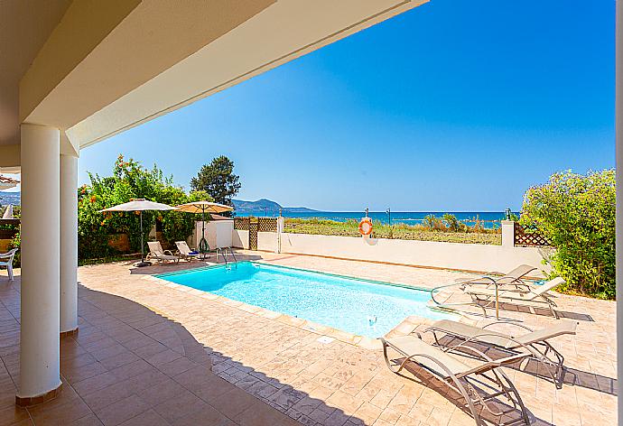 Sheltered terrace area with sea views . - Achilles Beach Villa . (Photo Gallery) }}