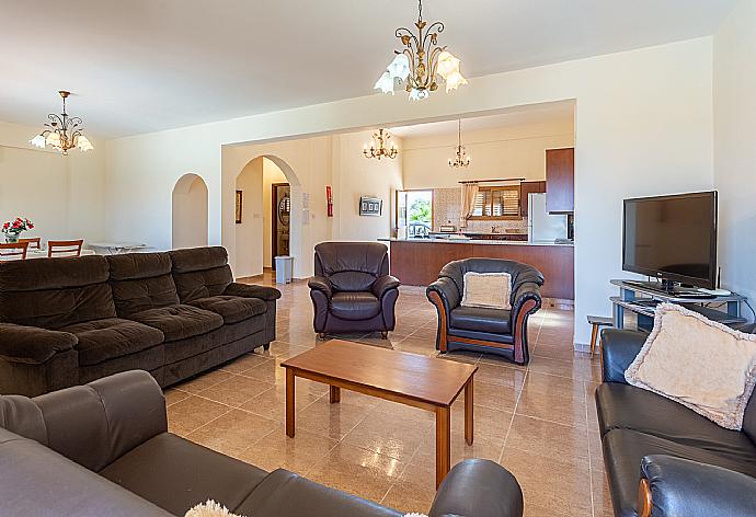 Open-plan living room with sofas, dining areas, kitchen, A/C, WiFi internet, satellite TV, and terrace access . - Achilles Beach Villa . (Fotogalerie) }}