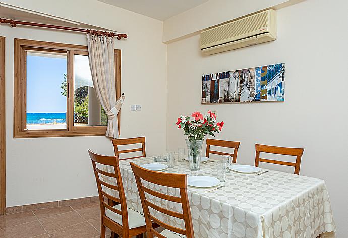 Open-plan living room with sofas, dining areas, kitchen, A/C, WiFi internet, satellite TV, and terrace access . - Achilles Beach Villa . (Fotogalerie) }}