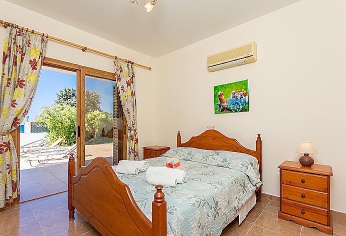 Double bedroom with en suite bedroom and A/C . - Achilles Beach Villa . (Photo Gallery) }}