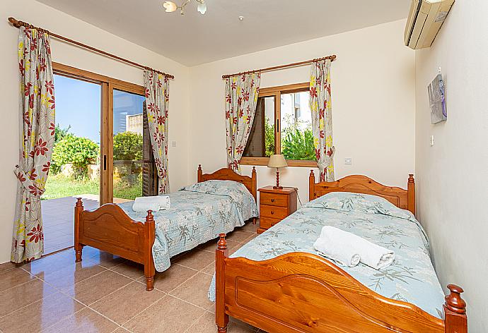 Twin bedroom with en suite bathroom and A/C . - Achilles Beach Villa . (Photo Gallery) }}