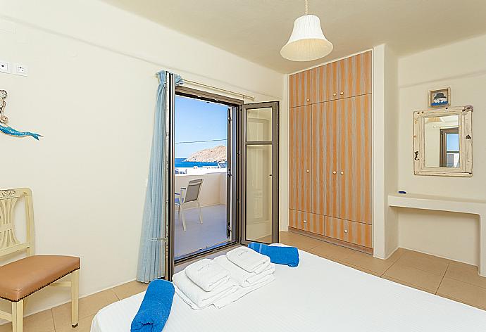 Double bedroom with en suite bathroom, A/C, and balcony with sea views . - Villa Almira . (Photo Gallery) }}