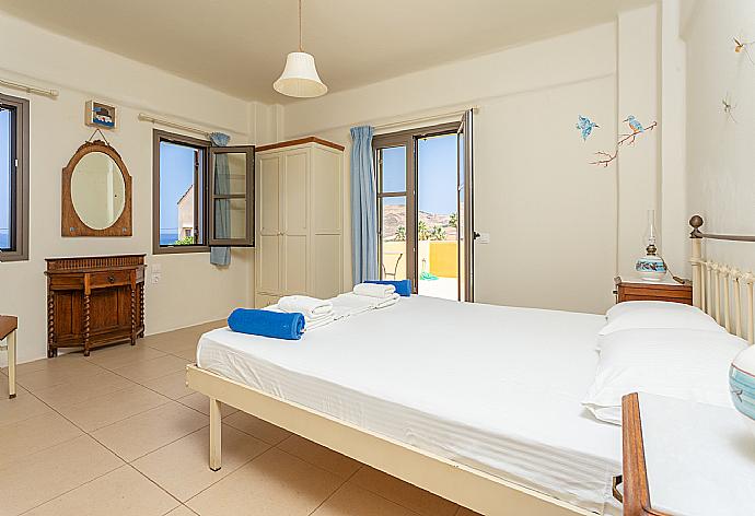 Double bedroom with A/C and balcony access with sea views . - Villa Liakada . (Photo Gallery) }}