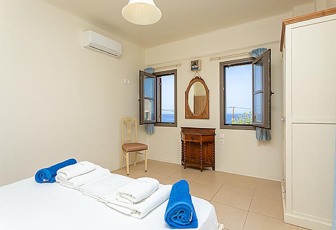 Double bedroom with A/C and balcony access with sea views . - Villa Liakada . (Photo Gallery) }}