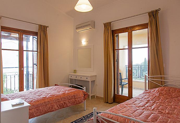 Twin bedroom with A/C, balcony access and en suite bathroom  . - Villa Christina . (Photo Gallery) }}