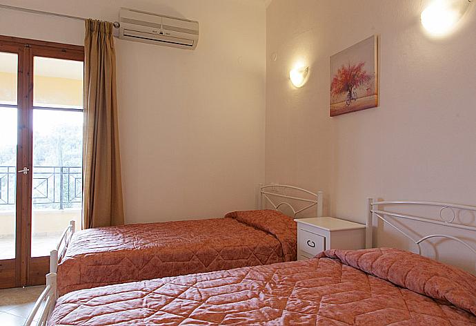 Twin bedroom with A/C, balcony access and en suite bathroom  . - Villa Christina . (Photo Gallery) }}