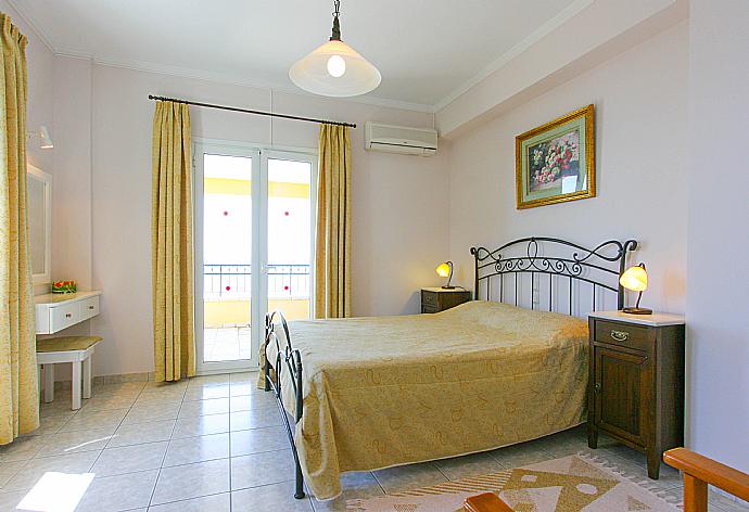 Double bedroom with A/C, balcony access and e suite bathroom . - Villa Spyros . (Photo Gallery) }}