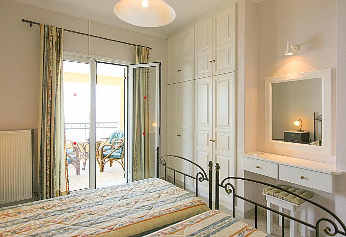 Twin bedroom with A/C, balcony access and e suite bathroom . - Villa Spyros . (Photo Gallery) }}