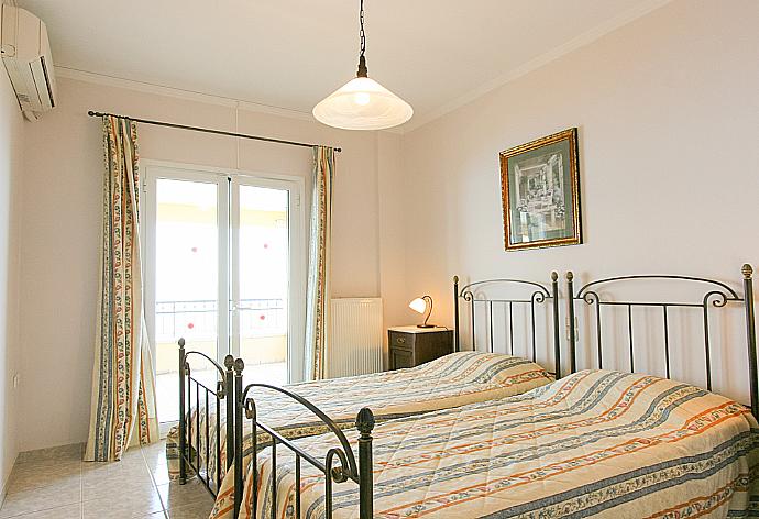 Twin bedroom with A/C and balcony access . - Villa Spyros . (Photo Gallery) }}