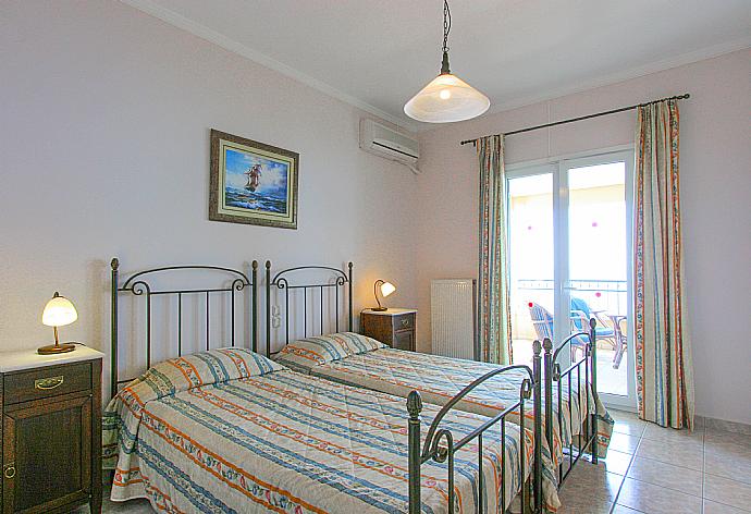 Twin bedroom with A/C with balcony access . - Villa Spyros . (Photo Gallery) }}