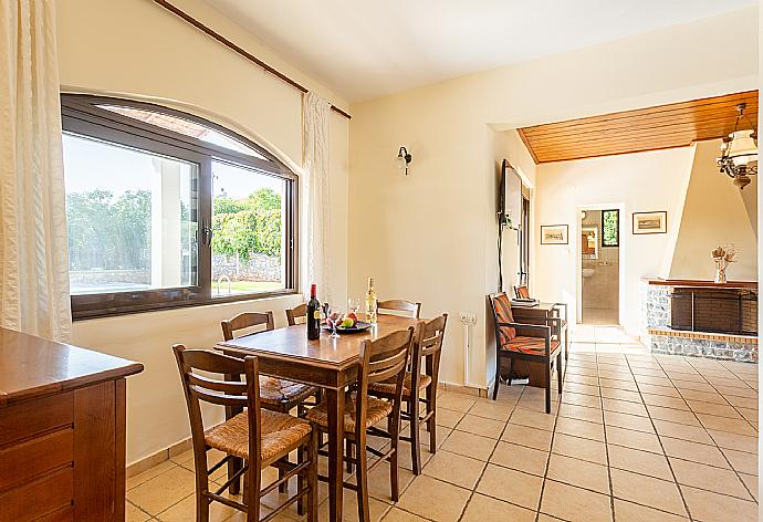 Living room with sofas, dining area, ornamental fireplace, satellite TV, WiFi Internet, DVD player, and terrace access . - Ekklisies Dio . (Galerie de photos) }}