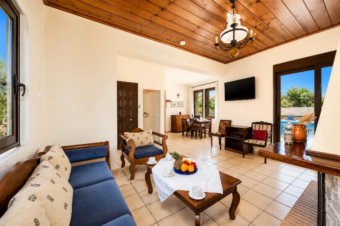 Living room with sofa, ornamental fireplace, WiFi internet, and satellite TV . - Ekklisies Tria . (Photo Gallery) }}