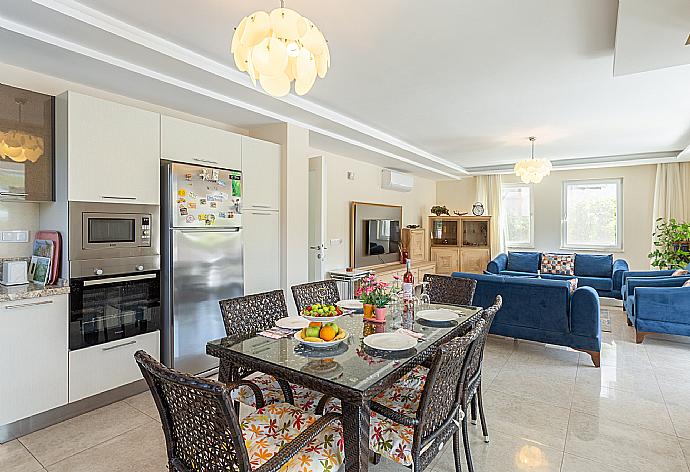 Open-plan living room with sofas, dining area, kitchen, A/C, WiFi internet, satellite TV, and terrace access . - Villa Seda . (Fotogalerie) }}