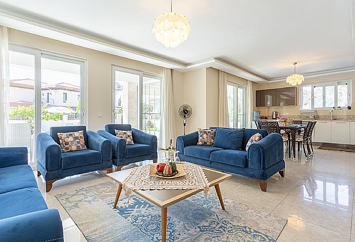 Open-plan living room with sofas, dining area, kitchen, A/C, WiFi internet, satellite TV, and terrace access . - Villa Seda . (Fotogalerie) }}