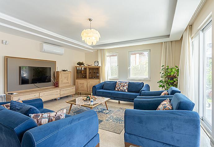 Open-plan living room with sofas, dining area, kitchen, A/C, WiFi internet, satellite TV, and terrace access . - Villa Seda . (Галерея фотографий) }}