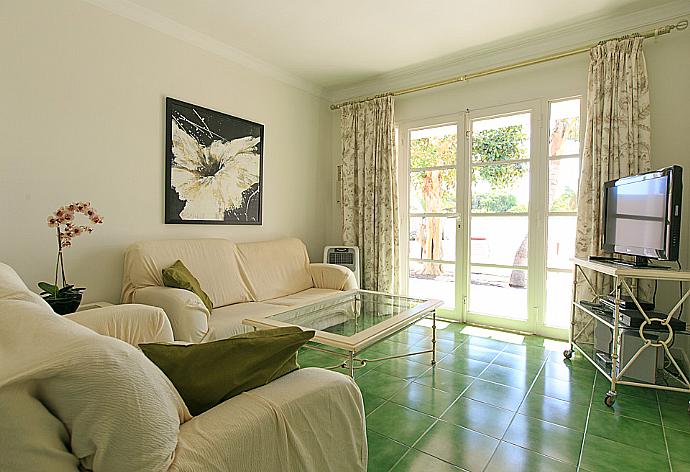 Living room with sofas, A/C, WiFi internet, satellite TV, DVD player, and terrace access . - Villa Sol . (Photo Gallery) }}