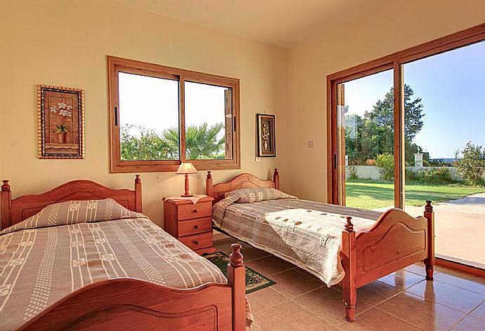 Twin bedroom with en suite bathroom, A/C, and terrace access . - Achilles Beach Villa Thio . (Fotogalerie) }}