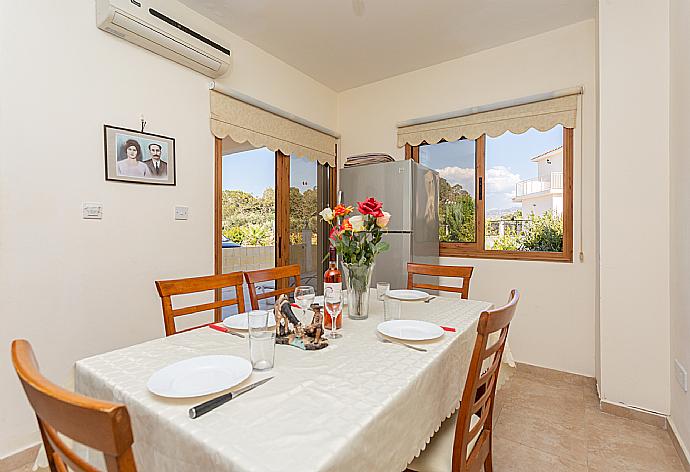 Open-plan living room with sofas, dining area, kitchen, A/C, WiFi internet, satellite TV, and terrace access . - Hector Beach Villa . (Galleria fotografica) }}