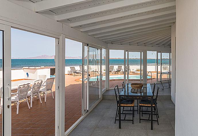 Sheltered terrace with dining table  . - Villa Remos . (Photo Gallery) }}