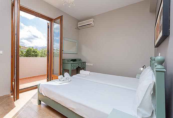 Twin bedroom with A/C and balcony access . - Villa Stratos . (Photo Gallery) }}