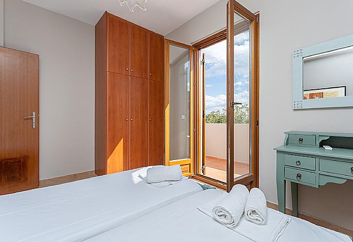 Twin bedroom with A/C and balcony access . - Villa Stratos . (Photo Gallery) }}