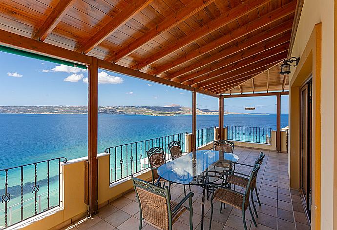 Sheltered balcony with outdoor seating and panoramic sea views . - Souda Bay View . (Photo Gallery) }}