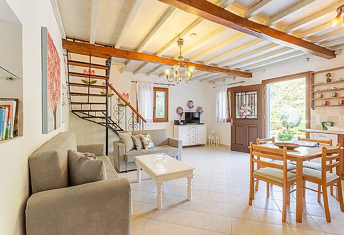 Open-plan living room with sofas, DVD player and dining area. . - Villa Glysteri . (Galleria fotografica) }}