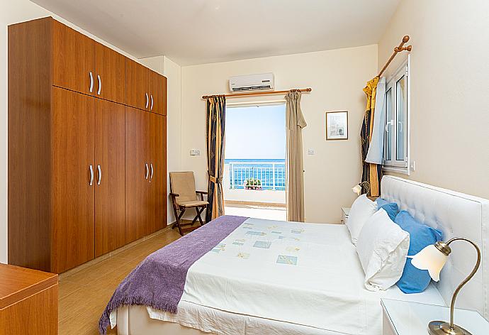 Double bedroom with en suite bathroom, A/C, and upper terrace access with panoramic sea views . - Kalisto Beach Villa . (Photo Gallery) }}