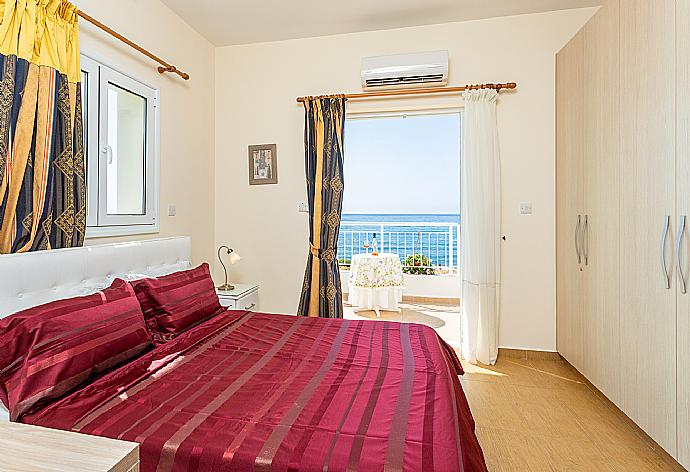 Double bedroom with en suite bathroom, A/C, and upper terrace access with panoramic sea views . - Kalisto Beach Villa . (Photo Gallery) }}