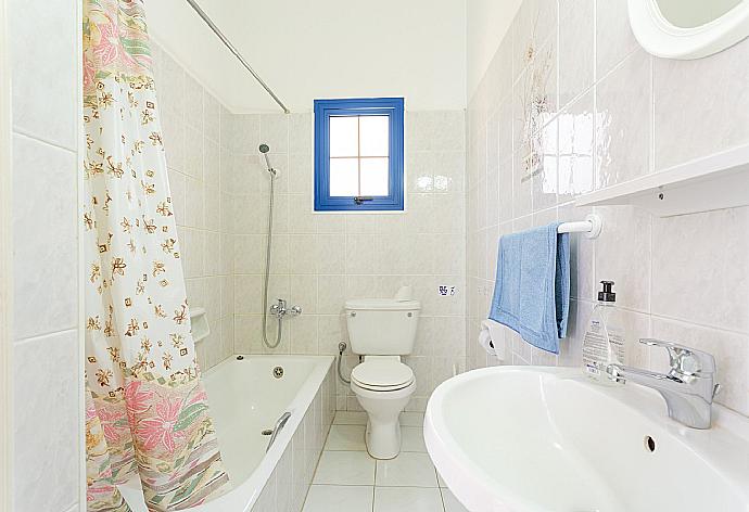En suite bathroom with bath and shower . - Villa Charoula Thio . (Photo Gallery) }}