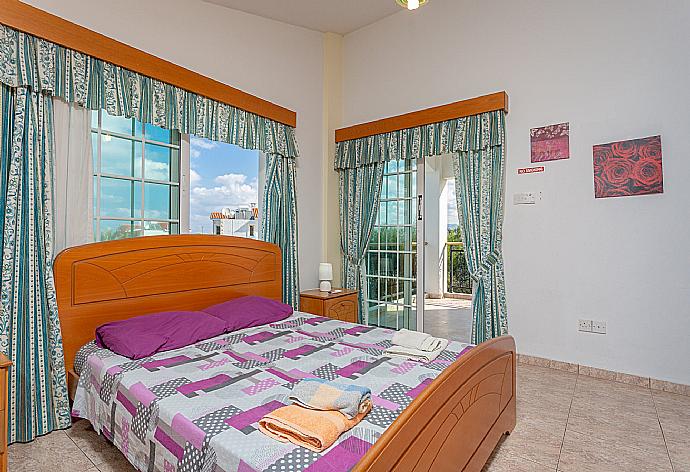 Double bedroom with en suite bathroom, A/C, and balcony access with sea views . - Villa Iliada . (Photo Gallery) }}