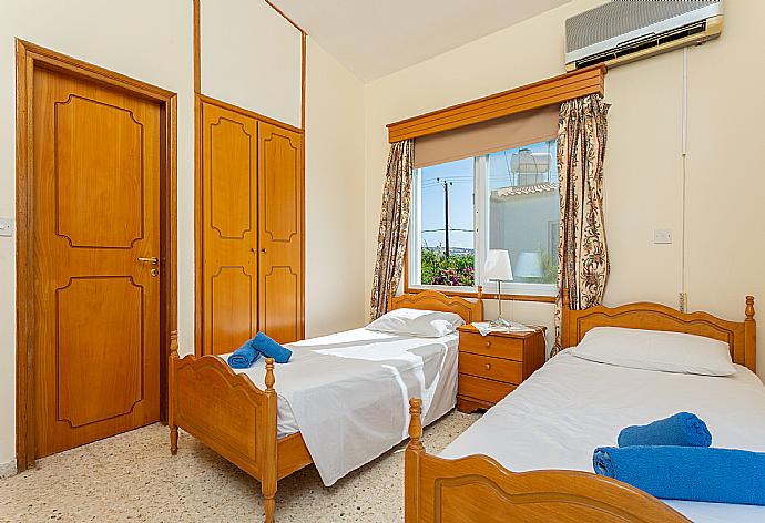 Twin bedroom with en suite bathroom, A/C, and balcony access with sea views . - Argaka Sun Villa Thio . (Photo Gallery) }}