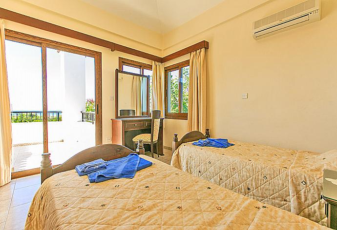 Twin bedroom with A/C  and balcony access . - Villa Solon . (Photo Gallery) }}