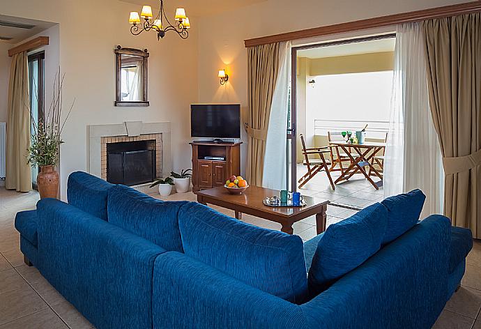 Living room with WiFi, TV, DVD player and terrace access . - Villa Ilia . (Photo Gallery) }}