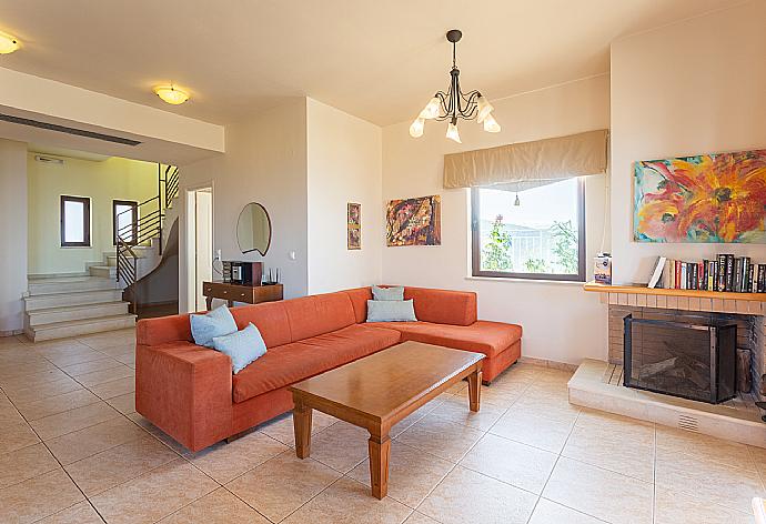 Open-plan living room with sofa, dining area, kitchen, ornamental fireplace, WiFi internet, satellite TV, DVD player, and terrace access . - Villa Selini . (Galleria fotografica) }}