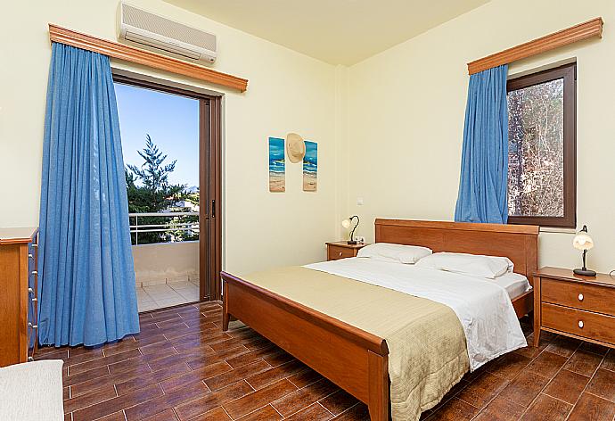 Double bedroom with en suite bathroom, A/C, and balcony access . - Villa Selini . (Photo Gallery) }}