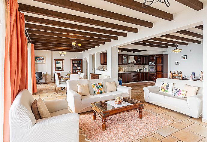 Open-plan living room with sofas, dining areas, kitchen, ornamental fireplace, WiFi internet, satellite TV, and terrace access with panoramic sea views . - Villa Emilios . (Galleria fotografica) }}