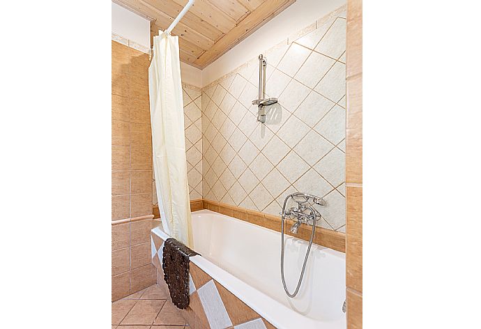 En suite bathroom with bath and shower . - Villa Emilios . (Photo Gallery) }}