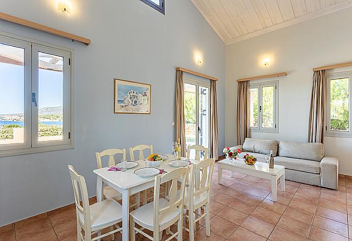 Open-plan living room with sofa, dining area, kitchen, mezzanine, A/C, WiFi internet, satellite TV, sea views, and terrace access . - Maria Beach House . (Galleria fotografica) }}