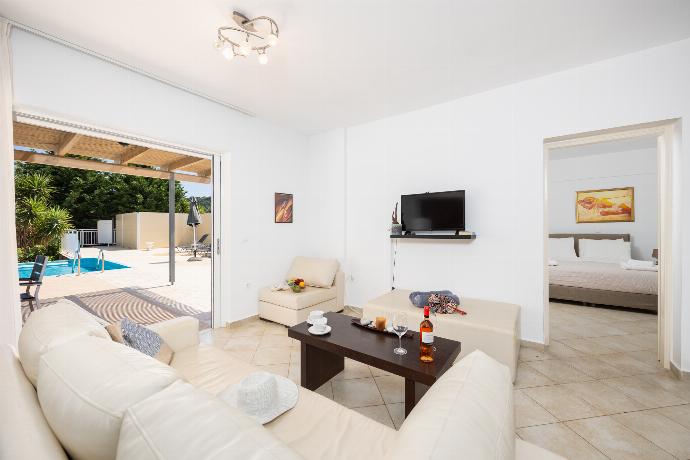 Open-plan living room with sofa, dining area, kitchen, A/C, WiFi internet, and satellite TV . - Villa Cherry . (Photo Gallery) }}