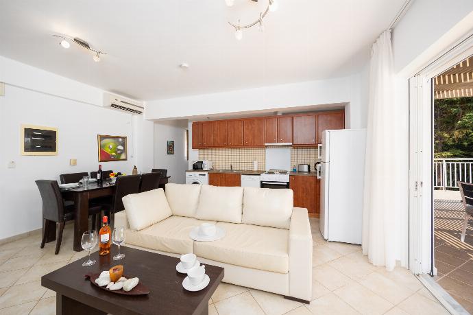 Open-plan living room with sofa, dining area, kitchen, A/C, WiFi internet, and satellite TV . - Villa Cherry . (Photo Gallery) }}