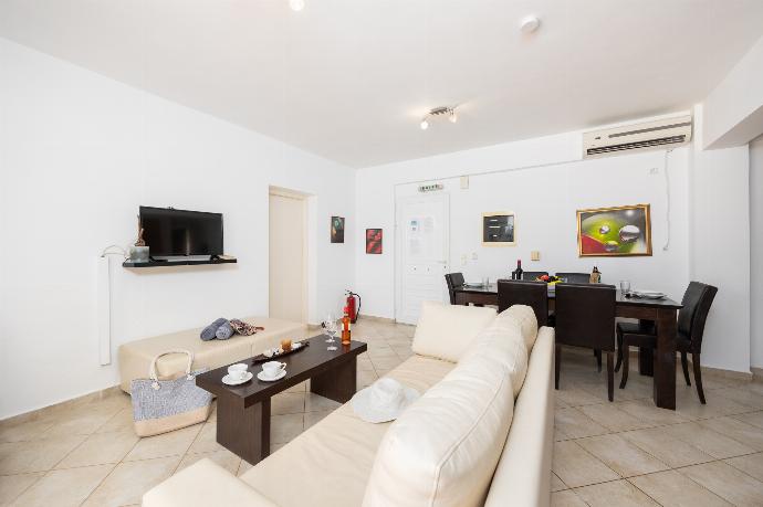 Open-plan living room with sofa, dining area, kitchen, A/C, WiFi internet, and satellite TV . - Villa Cherry . (Photo Gallery) }}