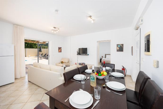 Open-plan living room with sofa, dining area, kitchen, A/C, WiFi internet, and satellite TV . - Villa Cherry . (Photo Gallery) }}