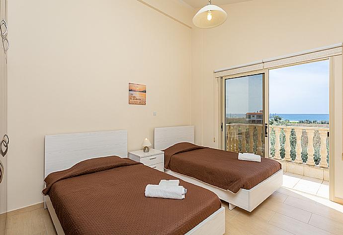 Twin bedroom with A/C, sea views, and balcony access . - Villa Rose . (Photo Gallery) }}