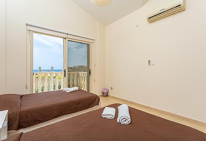 Twin bedroom with A/C, sea views, and balcony access . - Villa Rose . (Photo Gallery) }}