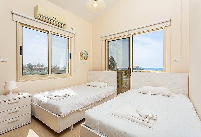 Twin bedroom with A/C, sea views, and balcony access . - Villa Rose . (Photo Gallery) }}