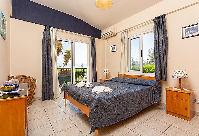 Double bedroom with A/C, en suite bathroom, and deck access . - Villa Chrystalla . (Photo Gallery) }}