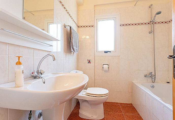 Family bathroom with bath and overhead shower . - Villa Chrystalla . (Photo Gallery) }}