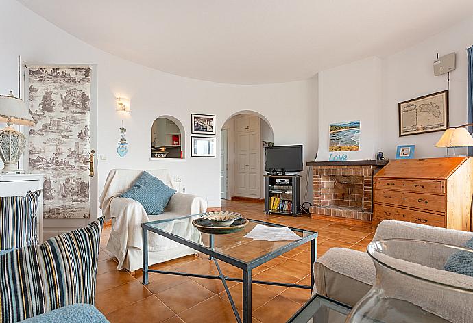 Living room with sofas, WiFi internet, TV, DVD player, ornamental fire place, and pool terrace access  . - Villa Caprice . (Fotogalerie) }}