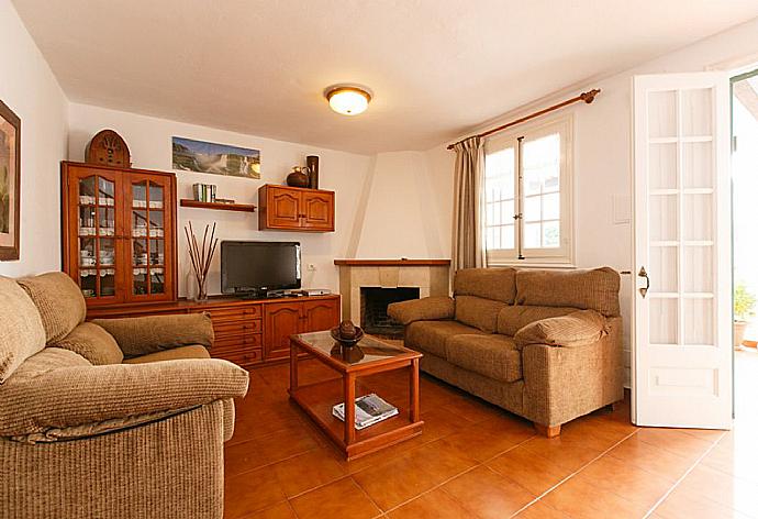 Living room has sofas, ornamental fireplace, WiFi internet, satellite TV, DVD player, and terrace access . - Villa Pepa . (Galería de imágenes) }}